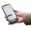 Hendriks Housing - Website of Hendriks Housing shown on smartphone held in hand- No background with shadow